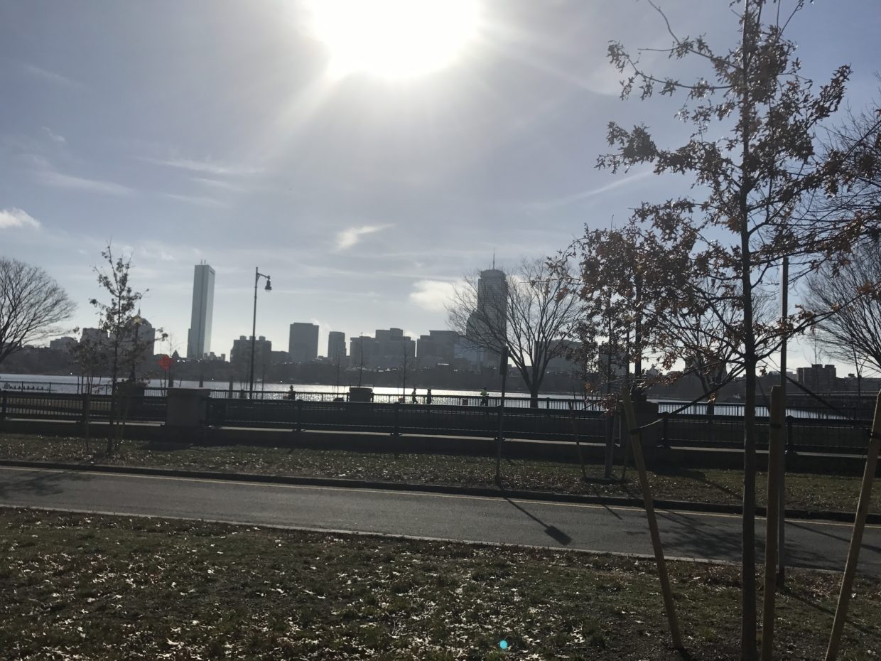 [IMAGE] Morning on the Charles River looking towards Boston from Cambridge. A road is in the foreground, the Boston skyline in the background. There are no cars or people.