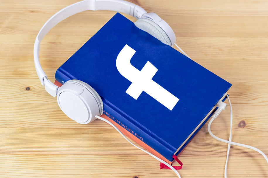 [IMAGE] A book with the Facebook logo on it and a pair of headphones wrapped around the book